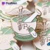 Une variété d'épingles à pharmacie colorées sont présentées sur une surface blanche propre, mettant en valeur leurs conceptions et détails uniques.