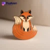 A stylish pin featuring an orange fox design, perfect for adding a whimsical touch to any accessory collection.