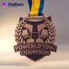 A close-up of a powerlifting champion medal, showcasing its intricate design and the words "Champion" engraved on it.