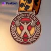 Gold powerlifting medal with a ribbon, symbolizing achievement in strength and athletic excellence.