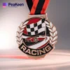 A detailed view of a racing medallion, showcasing the engraved word "Racing" on its shiny surface.