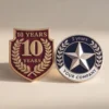 A commemorative pin celebrating 10 years of service at the company, featuring a sleek design and the company logo.