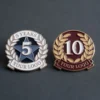 Two service lapel pins displaying "5 years" and "10 years" to commemorate employee milestones.
