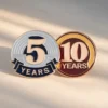 A pair of service pins representing five and ten years of dedicated service.