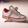 A white Converse shoe pin featuring vibrant red laces, perfect for adding flair to any accessory collection.