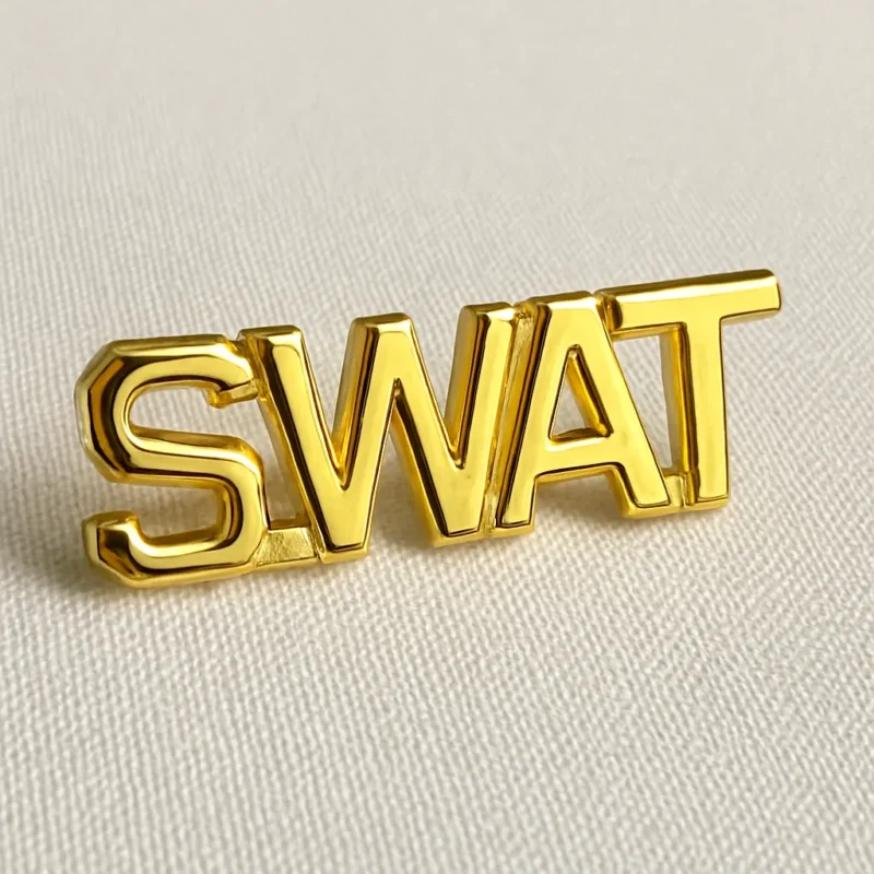 Gold SWAT badge pin featuring a detailed design, symbolizing tactical law enforcement authority.