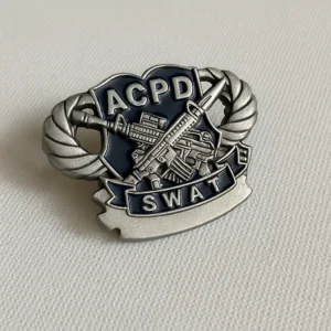 Badge displaying the words "ACPD SWAT," representing a special weapons and tactics unit.