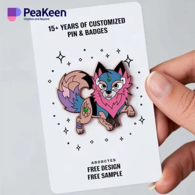 A hand holding a colorful pin featuring a cartoon fox design, showcasing a playful animal-themed accessory.