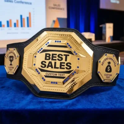 Gold best sales champion belt trophy with custom text, featuring Top Performer and Record Breaker side plates, displayed at a corporate conference