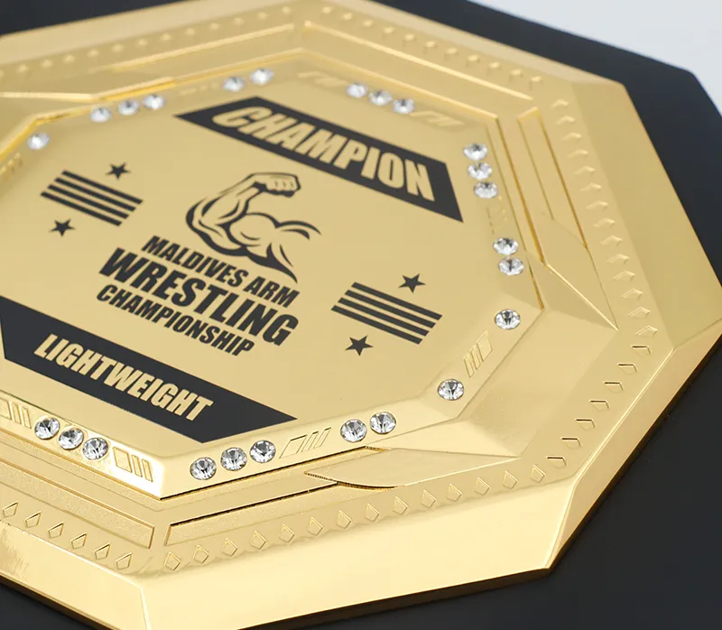 Championship wrestling belt in gold and black, adorned with diamonds and a bold black and white pattern.