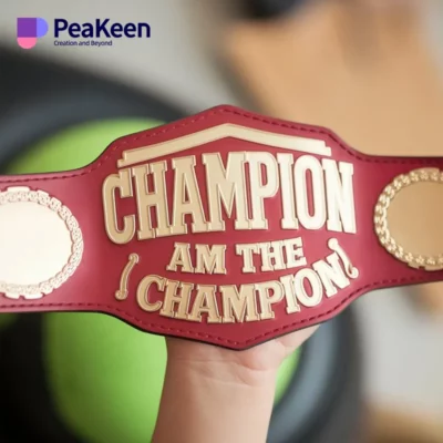 A young winner displays a championship belt inscribed with "Champion," showcasing their achievement in a children's competition.