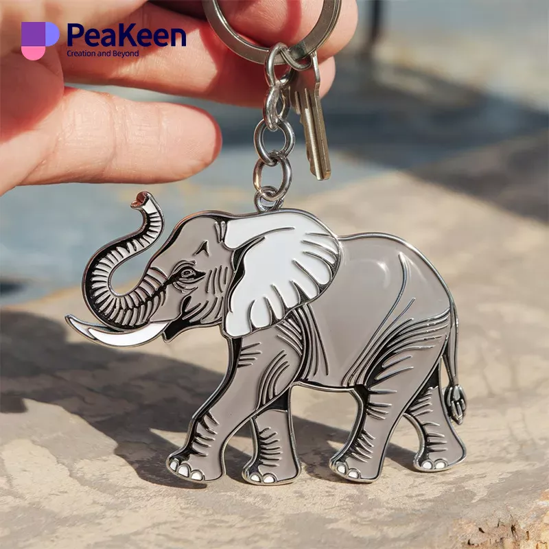 Close-up of a hand grasping a metal elephant keychain, showcasing its intricate details.