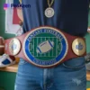 A man proudly displays a fantasy football champion belt, showcasing his victory in the championship.
