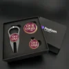 Golf gift set featuring a bottle opener and golf ball, elegantly presented in a stylish gift box.