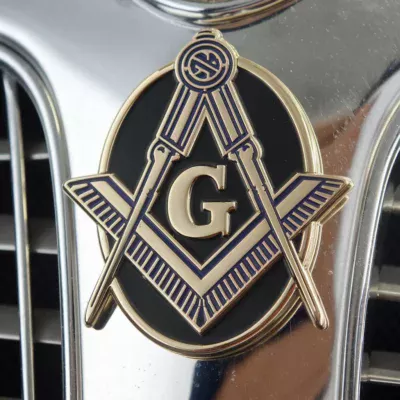 The hood of a car featuring a detailed masonic emblem, symbolizing fraternity and craftsmanship in a striking display.