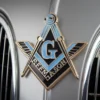 The front of a car adorned with a Masonic emblem, highlighting the significance of Masonic symbols in society.