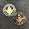 Two Masonic pins featuring emblems displayed on a black surface, highlighting their intricate designs and symbolism.