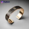 A gold cuff bracelet featuring a bird design, enhanced with soft enamel for a vibrant finish.