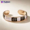 Elegant peeken bracelet made of soft enamel, showcasing a chic black and white pattern.