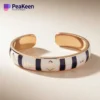 Elegant soft enamel peeken bracelet showcasing a blend of gold and black enamel for a chic accessory.
