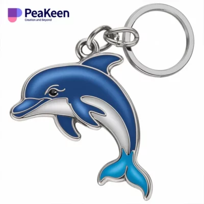 A blue and white metal dolphin keychain, showcasing a charming marine design for personal accessories.