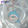 Metal dolphin keychain on a clear background, showcasing its sleek design and vibrant details.