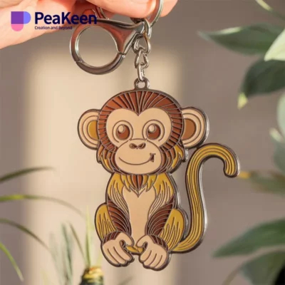 Soft enamel monkey keychain in focus, with a vibrant green plant softly blurred in the background.