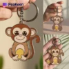 Soft enamel peeken monkey keychain featuring a playful design, perfect for adding charm to your keys or bag.