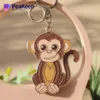 Adorable soft enamel monkey keychain with a brown and white face, ideal for a fun accessory on your keyring.
