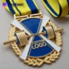 Custom gold medal for weightlifting, featuring a blue ribbon, showcasing excellence in athletic achievement.