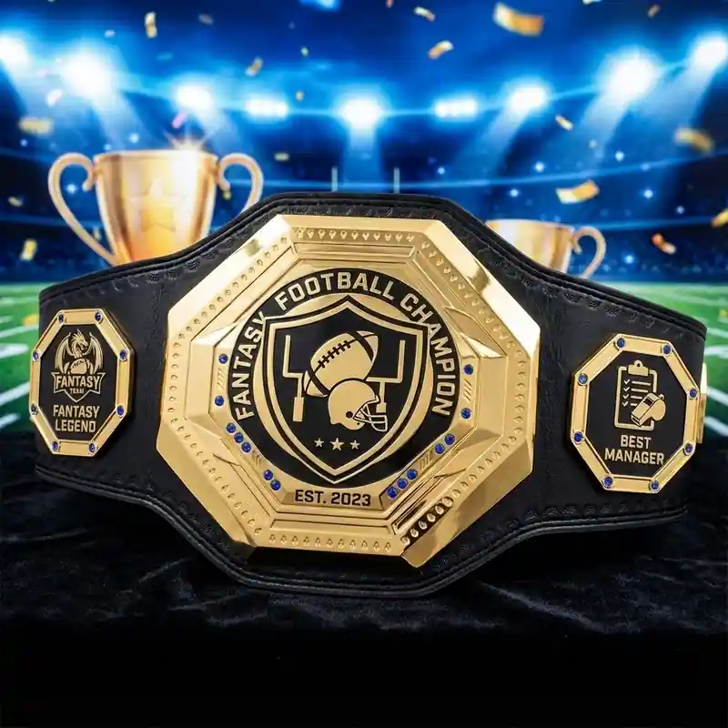 Gold fantasy football champion belt with Best Manager and Fantasy Legend side plates displayed in a stadium background
