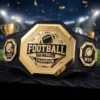 Gold fantasy football champion belt with League Winner and MVP side plates displayed on a football stadium background
