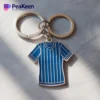 A jersey keychain designed like a blue and white striped shirt, ideal for adding a sporty touch to your keys.