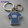 Unique jersey keychain in the shape of a blue and white striped shirt, a stylish accessory for any sports enthusiast.