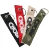 Three woven keychains in different colors, each featuring the word "oko" prominently displayed.