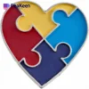 Colorful heart-shaped puzzle piece, representing autism, featuring four distinct segments in vibrant hues.
