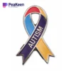 Colorful autism ribbon pin displaying the word "peakeen" representing advocacy and understanding for the autism community.