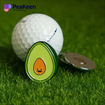 A golf ball featuring a vibrant avocado design, perfect for a unique ball marker clip.