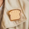 Detailed close-up of a toast pin, highlighting its golden-brown color and realistic texture, ideal for bread lovers.