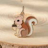 Una encantadora figurita de ardilla con una nuez en la boca, que presenta un diseño juguetón y colores vibrantes.