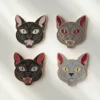 Four colorful horror cat enamel pins featuring unique designs and expressions.