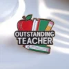 Enamel pin featuring the phrase "Outstanding Teacher," designed for educators to celebrate their achievements.