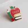 Enamel pin featuring a teacher design, showcasing a symbol of appreciation for educators.