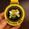 A medal featuring the words "Spelling Bee" prominently displayed on its surface.