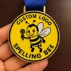 Custom logo medal for a spelling bee, featuring intricate design and text highlighting the event's name.