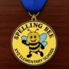 A medal featuring the words "Spelling Bee" prominently displayed on its surface.