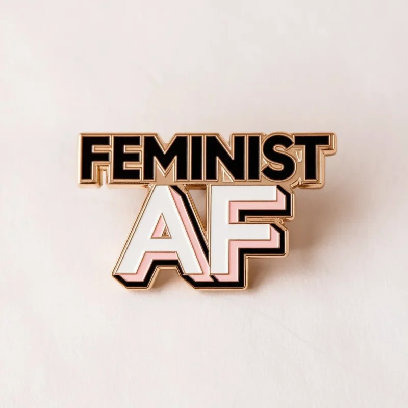 A colorful enamel pin displaying "Feminist AF," symbolizing strong support for feminist movements and equality.