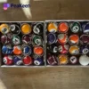 A box of billiard balls secured with a chain, featuring a billiards-themed keychain attached.