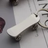 Metal keychain shaped like a skateboard, featuring detailed design and vibrant colors.