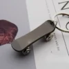 Metal keychain shaped like a skateboard, featuring detailed design and vibrant colors.
